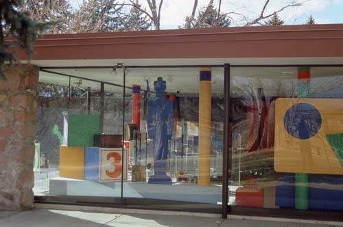 Photo from outside looking in windows showing oversized toys